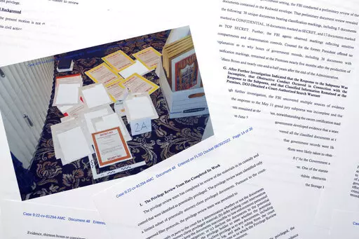 Pages from a Department of Justice court filing on Aug. 30, 2022, in response to a request from the legal team of former President Donald Trump for a special master to review the documents seized during the Aug. 8 search of Mar-a-Lago, are photographed early Wednesday, Aug. 31, 2022. Included in the filing was a FBI photo of documents that were seized during the search. (AP Photo/Jon Elswick)