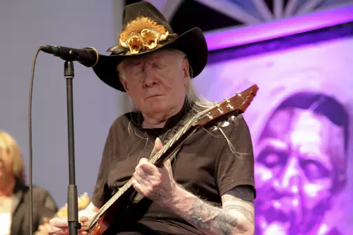 Johnny Winter performs at the New Orleans Jazz & Heritage Festival at Fair Grounds Race Course in New Orleans, May 3, 2014. Nearly nine years after Johnny Winter's death, a battle for control of the legendary blues guitarist's music is being fought in a Connecticut court with nasty allegations of theft and greed flying. (Photo by John Davisson/Invision/AP, File)