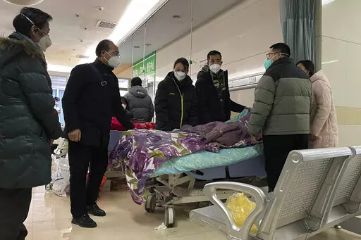 A man pulls a cloth to cover up the face of an elderly woman whose vitals flatlined as emotional relatives gather silently around her for a final farewell before her body is taken away at the emergency department of the Langfang No. 4 People's Hospital in Bazhou city in northern China's Hebei province on Thursday, Dec. 22, 2022. As China grapples with its first-ever wave of COVID mass infections, emergency wards in the towns and cities to Beijing's southwest are overwhelmed. Intensive care units