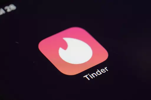 The icon for the dating app Tinder appears on a device, July 28, 2020, in New York. Tinder, Hinge and other dating apps are designed with addictive features that encourage “compulsive” use, a proposed class action lawsuit against parent company Match Group claims. The lawsuit filed Wednesday, Feb. 14, 2024, says Match intentionally designs its dating platforms with game-like features that “lock users into a perpetual pay-to-play loop” prioritizing profit over promises to help users find 