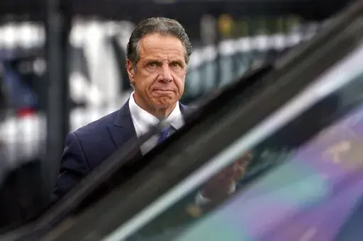 FILE - New York Gov. Andrew Cuomo prepares to board a helicopter after announcing his resignation, on Aug. 10, 2021, in New York. Cuomo won't face criminal charges after a female state trooper said she felt “completely violated” by his unwanted touching at an event at Belmont Park in September 2019, a Long Island prosecutor said Thursday, Dec. 23, 2021. Acting Nassau County District Attorney Joyce Smith said in a statement that an investigation found the allegations against Cuomo “credible