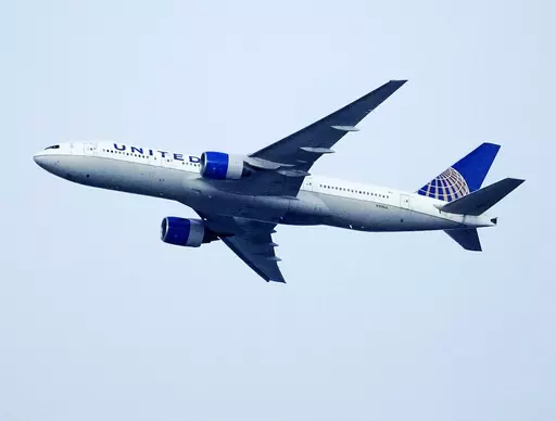 A United Airlines jetliner soars past an MLS soccer match July 8, 2023, in Commerce City, Colo. United Airlines and the union representing its pilots said Saturday, July 15, 2023, they reached agreement on a contract that will raise pilot pay by up to 40% over four years. (AP Photo/David Zalubowski, File)