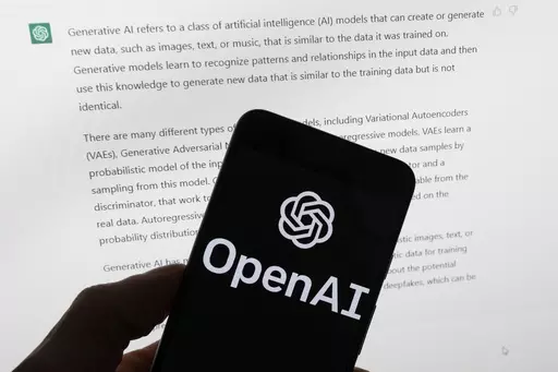 The OpenAI logo is seen on a mobile phone in front of a computer screen displaying output from ChatGPT, March 21, 2023, in Boston. As state lawmakers rush to get a handle on fast-evolving artificial intelligence technology, they're often focusing first on their own state governments before imposing restrictions on the private sector. Legislators are seeking ways to protect constituents from discrimination and other harms while not hindering cutting-edge advancements in medicine, science, busines