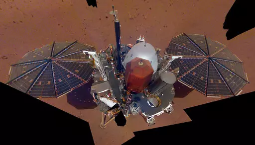 This Dec. 6, 2018 image made available by NASA shows the InSight lander. The scene was assembled from 11 photos taken using its robotic arm. The spacecraft is losing power because of all the dust that's accumulated on its solar panels. NASA said Tuesday, May 17, 2022, it will keep using the spacecraft's seismometer to detect marsquakes until its power peters out. Officials expect operations to cease in July, almost four years after InSight's arrival at Mars. (NASA via AP, File)