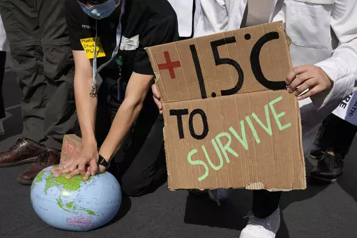 Demonstrators pretend to resuscitate the Earth while advocating for the 1.5 degree warming goal to survive at the COP27 U.N. Climate Summit, Nov. 16, 2022, in Sharm el-Sheikh, Egypt. Worldwide temperatures briefly exceeded a key warming threshold earlier this month, drawing notice from scientists and experts who warned of more extremes ahead as the planet enters an El Nino phase. (AP Photo/Peter Dejong, File)