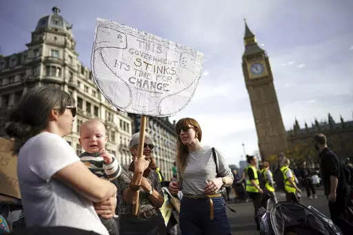 Demonstrators take part in the March of the Mummies national protest in central London, Saturday, Oct. 29 2022. The protest is organized by Pregnant Then Screwed to demand Government reform on childcare, parental leave and flexible working. (Aaron Chown/PA via AP)