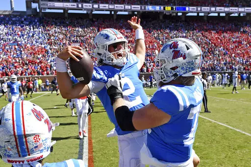 Mississippi quarterback Jaxson Dart (2) celebrates with offensive lineman Mason Brooks (75) after an NCAA college football game against Kentucky in Oxford, Miss., Saturday, Oct. 1, 2022. Mississippi won 22-19. (AP Photo/Thomas Graning)