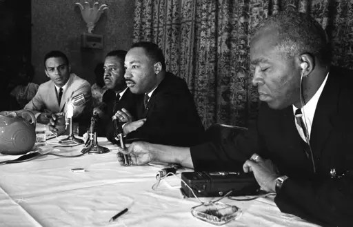 The Rev. Martin Luther King, center, speaks with the media at the Southern Christian Leadership Conference convention in Savannah, Ga., on Sept. 29, 1964. The March on Washington of 1963 was the product of sustained activism by broad coalition. The Black Church was not monolithic then nor now. (Savannah Morning News via AP, File)