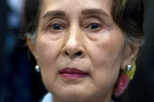 FILE - Myanmar's leader Aung San Suu Kyi waits to address judges of the International Court of Justice on the second day of three days of hearings in The Hague, Netherlands on Dec. 11, 2019.  (AP Photo/Peter Dejong, File)