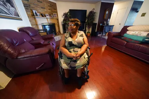 India Scott sits in the living room of her home in New Orleans, Monday, Oct. 10, 2022. Activists, advocates, researchers and people living with disabilities say not enough is being done to include disabled people in climate action planning and policy, or disaster relief and recovery efforts. (AP Photo/Gerald Herbert)