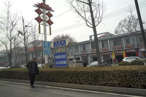 A man walks along the road in the city of Handan in northern China's Hebei province on Feb. 28, 2024. Chinese authorities in the Feixiang district near Handan city announced three suspects have been detained over the March 10, 2024 gruesome murder of a thirteen-year-old boy, riveting users on Chinese social media and sparking debate over bullying and mental health in China's countryside. (AP Photo/Emily Wang Fujiyama, File)