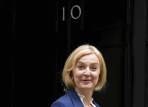 British Prime Minister Liz Truss leaves 10 Downing Street to attend her first Prime Minister's Questions at the Houses of Parliament, in London, Wednesday, Sept. 7, 2022. (AP Photo/Frank Augstein)