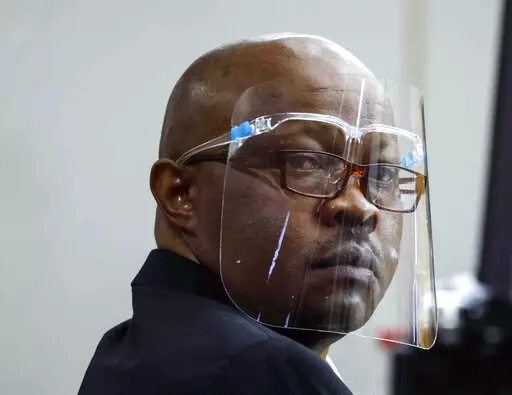 Accused serial killer Billy Chemirmir looks back during his retrial on April 25, 2022, at Frank Crowley Courts Building in Dallas. A man who has been charged with killing 22 women in the Dallas area is set to go on trial in the death of an 87-year-old woman. Billy Chemirmir's capital murder trial in the death of Mary Brooks is scheduled to begin Monday, Oct. 3, 2022, in Dallas. (Shafkat Anowar/The Dallas Morning News via AP, Pool, File)