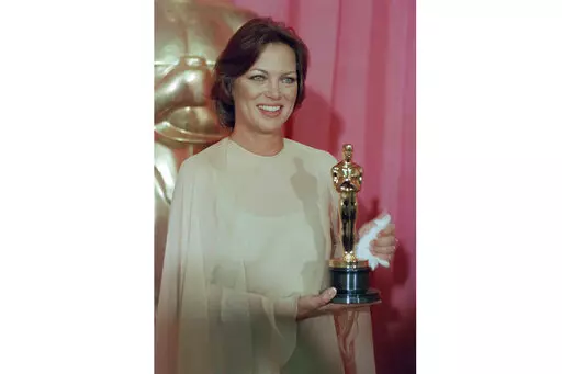 Louise Fletcher holds the Academy Award she won for her leading role in "One Flew Over The Cuckoo's Nest" in Los Angeles, March 30, 1976. Fletcher, a late-blooming star whose riveting performance as the cruel and calculating Nurse Ratched in "One Flew Over the Cuckoo's Nest" set a new standard for screen villains and won her an Academy Award, died Friday, Sept. 23, 2022, at age 88. (AP Photo/File)