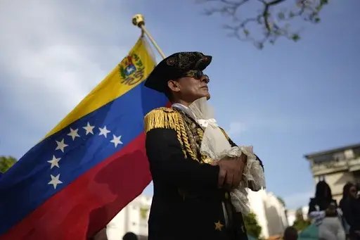 A man dressed as an independence fighter attends a political event with Venezuelan opposition presidential candidate Edmundo Gonzalez in Caracas, Venezuela, Thursday, June 13, 2024. No decision in Venezuela over the past 25 years has been as consequential as the choice voters will make on July 28. (AP Photo/Ariana Cubillos, File)