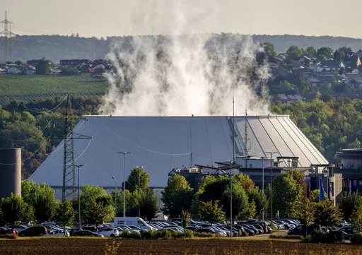 Smoke rises from the nuclear power plant of Nerckarwestheim in Neckarwestheim, Germany, on Aug. 22, 2022. Europe is staring an energy crisis in the face. The cause: Russia throttling back supplies of natural gas. European officials say it's a pressure game over their support for Ukraine after Russia's invasion. (AP Photo/Michael Probst, File)