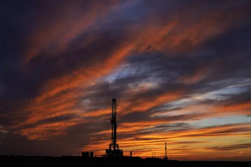 Oil drilling rigs are pictured at sunset, Monday, March 7, 2022, in El Reno, Okla. On Friday, May 5, The Associated Press reported on stories circulating online incorrectly claiming the planet has an unlimited supply of oil. (AP Photo/Sue Ogrocki, File)