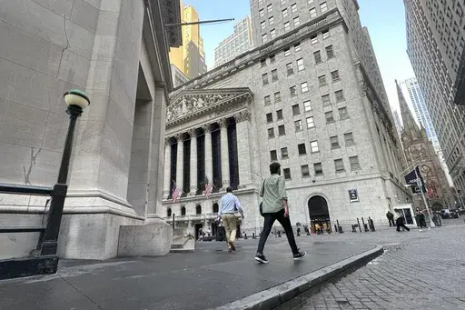 People approach the New York Stock Exchange on Aug. 27, 2024, in New York. (AP Photo/Peter Morgan, File)