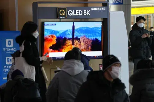 People watch a TV showing an image of North Korea's missile launch during a news program at the Seoul Railway Station in Seoul, South Korea, Monday, Jan. 31, 2022. North Korea confirmed Monday it test-launched an intermediate-range ballistic missile capable of reaching the U.S. territory of Guam, the North's most significant weapon launch in years, as Washington plans to respond to demonstrate it's committed to its allies' security in the region. (AP Photo/Ahn Young-joon)