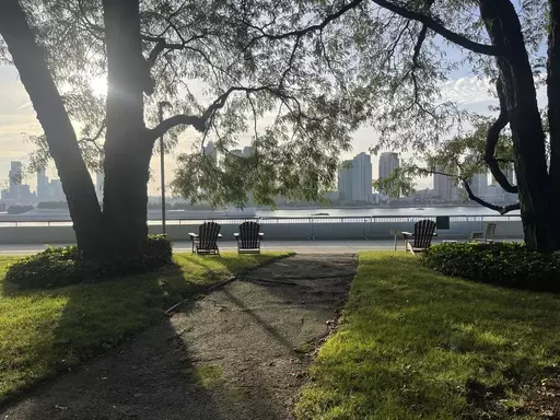 Chairs for contemplation look out upon the East River inside the U.N. compound in New York on Friday, Sept. 22, 2023. The parklet in the U.N. compound is a place where people go to find a few minutes of peace just yards from the buildings where leaders and diplomats deal with the world’s chaos. (AP Photo/Ted Anthony)