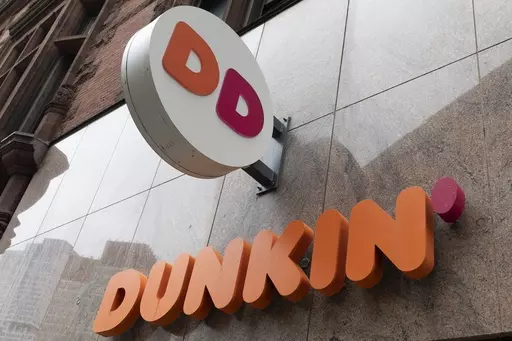 The Dunkin' logo is seen on a storefront, Friday, Oct. 14, 2022, in Boston. A customer in central Florida has filed a negligence lawsuit against Dunkin', claiming he was injured from an exploding toilet at one of the coffee chain's locations. (AP Photo/Michael Dwyer, File)