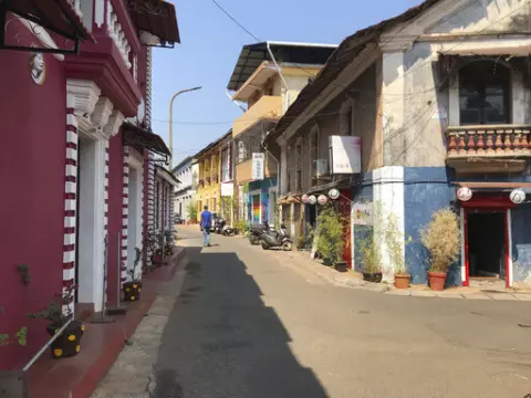 A man walks through a deserted street at Fontainhas, a UNESCO heritage site with Portugese style homes in Panjim, Goa, on Feb. 12, 2022. India's undisputed tourist hot spot, and the tiniest state in the world's largest democracy, is voting Monday to elect a new government with an eye toward restoring an economy ravaged by the pandemic and saving the environment threatened by an unbridled real estate boom. (AP Photo/Vineeta Deepak)
