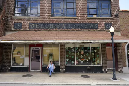 Missy Nester owner of the The Welch News sits in front of the now closed office on Wednesday, May 31, 2023, in Welch, W.Va. In March, the weekly publication in McDowell County one of the poorest counties America became another one of the quarter of all U.S. newspapers that have shuttered since 2005, a crisis Nester called "terrifying for democracy" and one that disproportionately impacts rural America. (AP Photo/Chris Carlson)