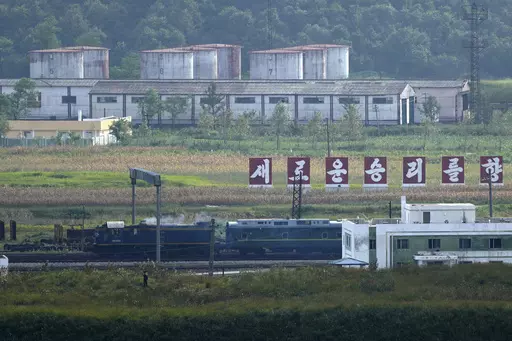 A green train with yellow trimmings, resembling one used by North Korean leader Kim Jong Un on his previous travels, is seen steaming by a slogan which reads "Towards a new victory" on the North Korea border with Russia and China seen from China's Yiyanwang Three Kingdoms viewing platform in Fangchuan in northeastern China's Jilin province on Monday, Sept. 11, 2023. Russia and North Korea confirmed Monday that North Korean leader Kim Jong Un will visit Russia in a highly anticipated meeting with