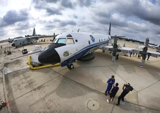 One of the National Oceanic and Atmospheric Administration's (NOAA) WP-3D Orion aircraft sits on the tarmac, with the U.S. Air Force Reserve 53rd Weather Reconnaissance Squadron's WC-130J, far left, during a stop at Orlando Sanford International Airport, in Sanford, Fla., Friday, May 10, 2024. The planes are "Hurricane Hunters" — flying science labs that navigates into the heart of tropical cyclones— collecting real-time storm data. (Joe Burbank /Orlando Sentinel via AP)