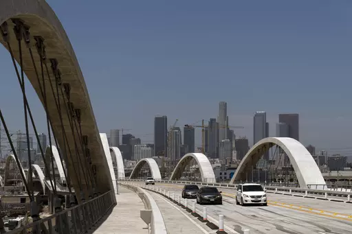 Cars move along the 6th Street Viaduct in Los Angeles, Wednesday, July 27, 2022. Police say a 17-year-old boy slipped and fell to his death this weekend while climbing a Los Angeles bridge in an apparent social media stunt. (AP Photo/Jae C. Hong, File)
