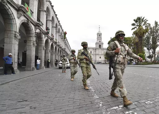 Soldiers patrol in Arequipa, Peru, Wednesday, Dec. 14, 2022. Peru’s new government declared a 30-day national emergency on Wednesday amid violent protests following the ouster of President Pedro Castillo, suspending the rights of “personal security and freedom” across the Andean nation. (AP Photo/Jose Sotomayor)