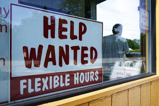 Help wanted sign is displayed in Deerfield, Ill., Wednesday, Sept. 21, 2022.  The number of available jobs in the U.S. plummeted in August compared with July, a sign that businesses may pull back further on hiring and potentially cool chronically high inflation.  There were 10.1 million advertised jobs on the last day of August, the government said Tuesday, Sept. 4, down a huge 10% from 11.2 million openings in July. In March, job openings had hit a record of nearly 11.9 million.  (AP Photo/Nam 