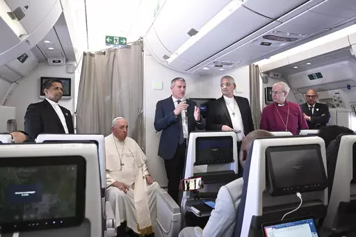 The Archbishop of Canterbury Justin Welby, right, Pope Francis,left, and the Moderator of the General Assembly of the Church of Scotland Iain Greenshields meet the journalists during an airborne press conference aboard the airplane directed to Rome, at the end of his pastoral visit to Congo and South Sudan, Sunday, Feb. 5, 2023. (Tiziana Fabi/Pool Photo Via AP)