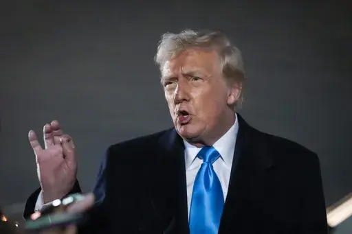 President Donald Trump speaks to reporters next to Air Force One after arriving back at Joint Base Andrews, Md., Sunday, Feb. 2, 2025. (AP Photo/Ben Curtis)
