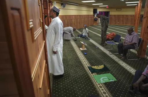 A member of the Abubakar As-Saddique Islamic Center recites the Islamic call to prayer, or adhan, on Thursday, May 12, 2022, in Minneapolis. The adhan exhorts men to go to the closest mosque five times a day for prayer, which is one of the Five Pillars of Islam. Abubakar, which hosts some 1,000 men for Friday midday prayers, plans to hold meetings with neighbors before publicly broadcasting publicly the call this summer. (AP Photo/Jessie Wardarski)
