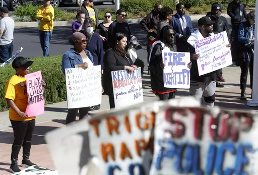 Community members listen to speakers during a rally at Antioch police headquarters in Antioch, Calif., on April 18, 2023. Racist police text messages containing slurs and images of gorillas will take center stage in a San Francisco Bay Area courtroom on Friday, July 21, 2023, as a judge weighs whether the messages violated a state law designed to stamp out racism in the criminal court system. (Jane Tyska/Bay Area News Group via AP)