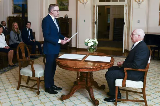Anthony Albanese is sworn in as Australia's Prime Minister by Australian Governor-General David Hurley, right, during a ceremony at Government House in Canberra, Monday, May 23, 2022. Albanese has been sworn in ahead of a Tokyo summit while vote counting continues to decide whether he will control a majority in a Parliament that is demanding tougher action on climate change. (Lukas Coch/AAP Image via AP)