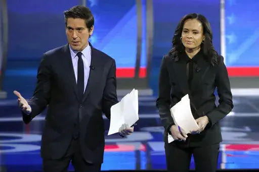 ABC World News Tonight Anchor David Muir, left, addresses members of the audience while standing with ABC News Live Anchor Linsey Davis, Friday, Feb. 7, 2020 in Manchester, N.H. The two planned presidential debates between Joe Biden and Donald Trump that were swiftly organized this week, Thursday, May 16, 2024, are good news for CNN and ABC News.(AP Photo/Elise Amendola, File)