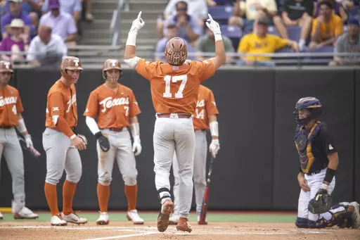 Texas' Ivan Melendez gestures at home plate after hitting a three-run home run during the first inning of an NCAA college super regional baseball game against East Carolina on Sunday, June 12, 2022, in Greenville, N.C. (AP Photo/Matt Kelley)