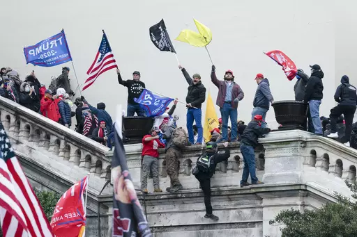 Rioters wave flags on the West Front of the U.S. Capitol in Washington on Jan. 6, 2021. (AP Photo/Jose Luis Magana, File)