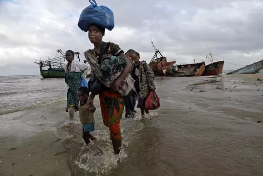 FILE — Displaced families arrive after being rescued by boat from a flooded area of Buzi district, 200 kilometers (120 miles) outside Beira, Mozambique, Saturday, March 23, 2019. Much of the world takes daily weather forecasts for granted. But most of Africa's 1.3 billion people live with little advance knowledge of what's to come. That can be deadly, with damage running in the billions of dollars. The first Africa Climate Summit opens this week in Kenya to highlight the continent that will su