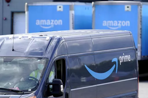 An Amazon Prime logo appears on the side of a delivery van as it departs an Amazon Warehouse location in Dedham, Mass., Oct. 1, 2020. Amazon Prime Day kicks off on Tuesday, July 11, 2023. And, once again, experts are warning consumers of scams. (AP Photo/Steven Senne, File)