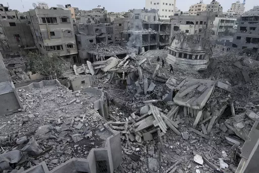 Palestinians inspect the rubble of the Yassin Mosque destroyed after it was hit by an Israeli airstrike at Shati refugee camp in Gaza City, early Monday, Oct. 9, 2023. (AP Photo/Adel Hana, File)