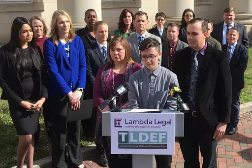 Connor Thonen-Fleck addresses reporters while his parents stand by his side, Monday March 11, 2019, in Durham, N.C., at the announcement of a lawsuit against North Carolina officials over how the state health plan is run. A federal appeals court is considering cases out of North Carolina and West Virginia that could have broad-ranging implications on whether individual states are constitutionally required to cover healthcare for transgender people with government-sponsored insurance. (AP Photo/ 