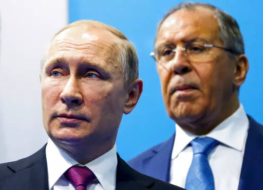 Russian President Vladimir Putin, left, and Foreign Minister Sergey Lavrov stand while waiting for Turkish President Recep Tayyip Erdogan prior to their talks at the G-20 summit in Hamburg, northern Germany,  July 8, 2017. In his role for nearly 18 years, Lavrov, 71, has seen relations with the West shift from near-friendly to openly hostile, plummeting to a catastrophic new low with the Russian war against Ukraine. The invasion prompted the European Union to freeze the assets of both Putin and 