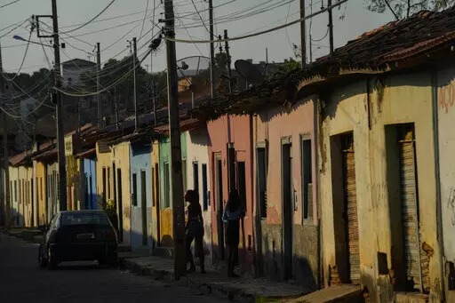 Residents stand on the sidewalk in Aracuai, Brazil, Oct. 11, 2022. Araçuai is part of the Jequitinhonha Valley in northern Minas Gerais state, bordering the poor northeast region that is a stronghold for former President Luiz Inacio Lula da Silva, who is running for president again. Gaining traction in Minas Gerais is especially important to incumbent Jair Bolsonaro, as the state has the second-largest population in the country. The two presidential candidates will face each other in a runoff O