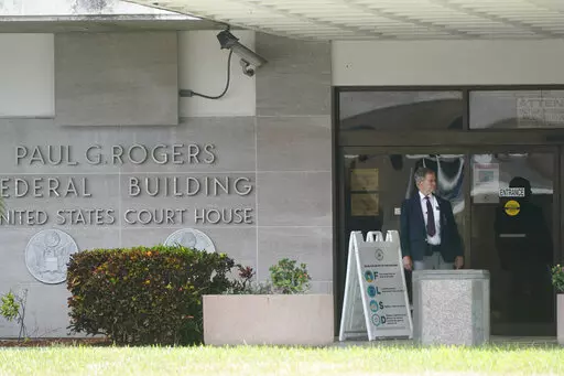 A security guard stands outside the Paul G. Rogers Federal Building and U.S. Courthouse, Thursday, Sept. 1, 2022, in West Palm Beach, Fla. A federal judge heard arguments Thursday on whether to appoint an outside legal expert to review government records seized by the FBI last month in a search of former President Donald Trump's Florida home. There was no immediate ruling. (AP Photo/Wilfredo Lee)