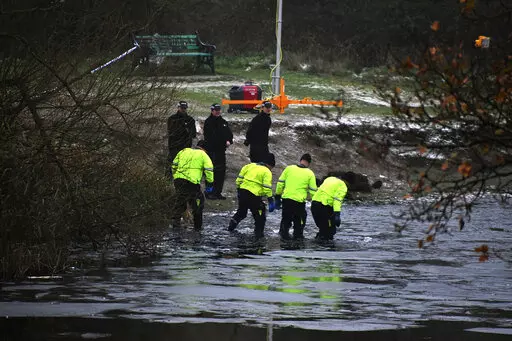 Police search teams at the scene after children fell through ice,in Babbs Mill Park in Kingshurst, Solihull, England, Monday, Dec. 12, 2022. Three young boys who fell through ice covering a lake in central England have died and a fourth remains hospitalized as weather forecasters issued severe weather warnings for large parts of the United Kingdom. Rescuers pulled the boys, aged 8, 10 and 11, from the icy waters Sunday afternoon and rushed them to the hospital in the West Midlands, about 100 mil