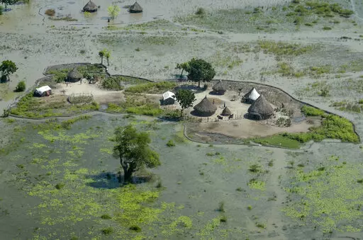 Thatched huts surrounded by floodwaters are seen from the air in Old Fangak county, Jonglei state, South Sudan, Nov. 27, 2020. South Sudan's President Salva Kiir Mayardit ordered the suspension Saturday, July 9, of all dredging-related activities in the country until evidence-based studies are carried out on their on surrounding communities and the ecosystems they rely on. (AP Photo/Maura Ajak, File)