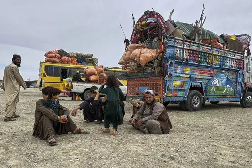 Afghan refugees take rest at a transit station setup to facilitate Afghan refugees' deportations, outskirt of Chaman, a town on the Pakistan and Afghanistan border, Tuesday, April 8, 2025. (AP Photo)